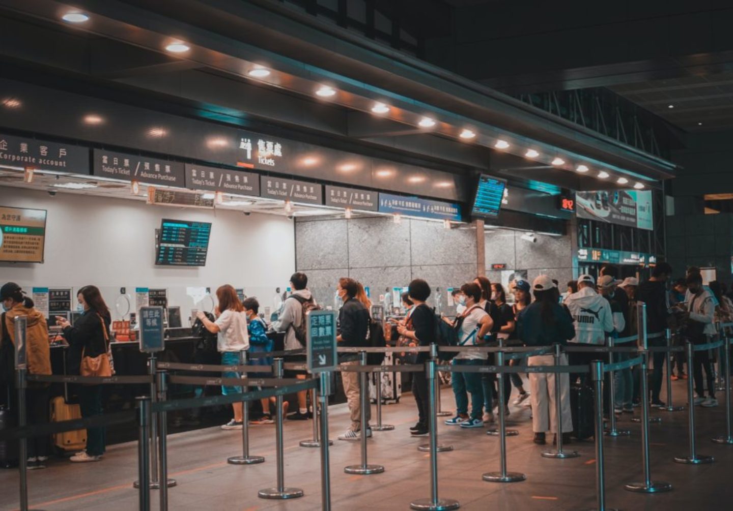 People standing in line at the airport check-in counter